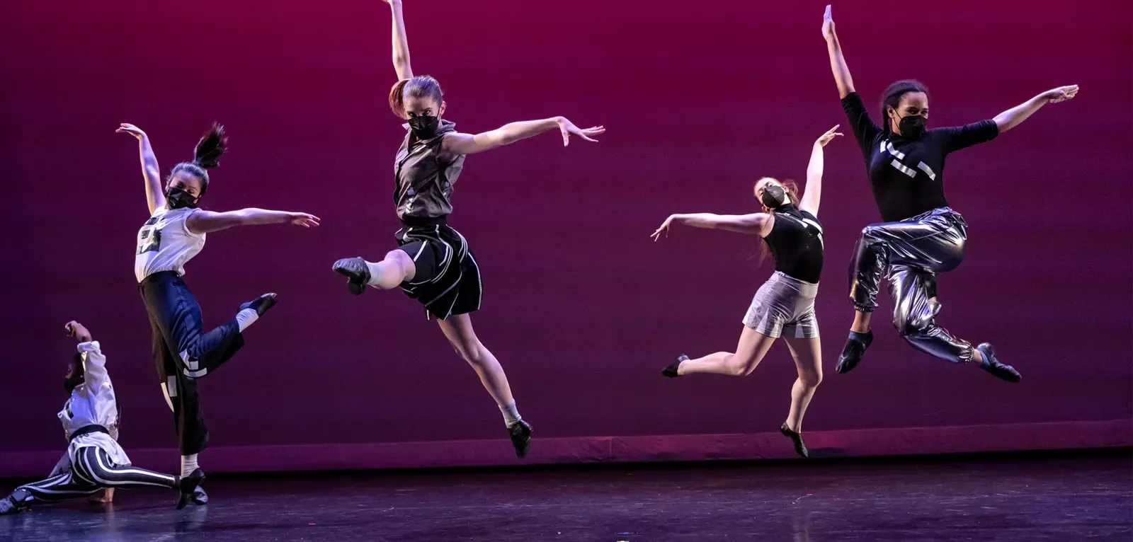 Image of dancers jumping on stage